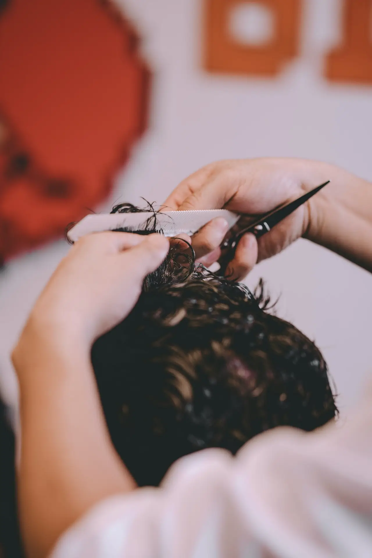 Close-up of professional barber scissors and comb, symbolizing the precision men's haircuts at Twin Blades Hair Studio in Scottsdale