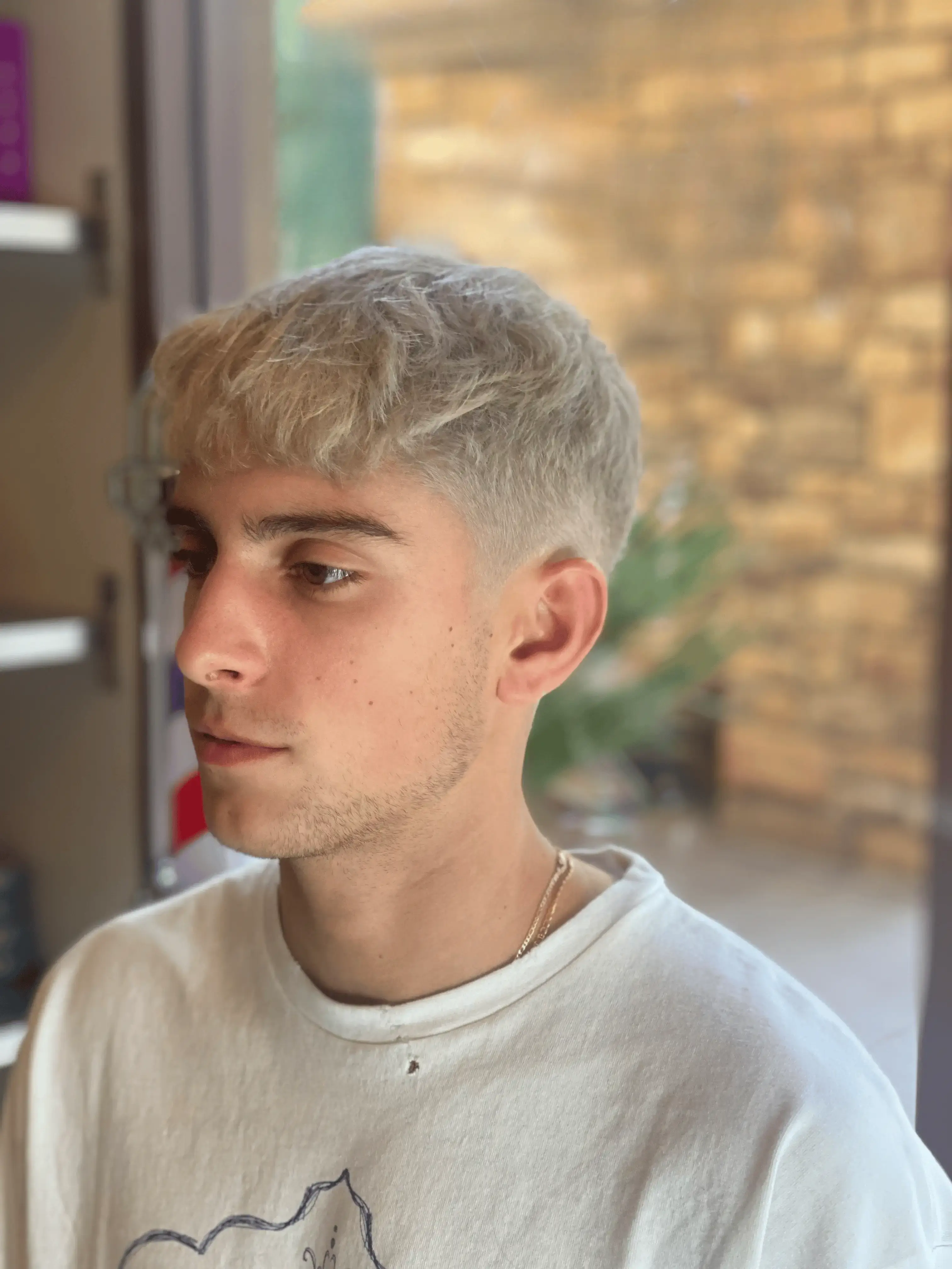 A vibrant, modern men's bleach and tone hairstyle