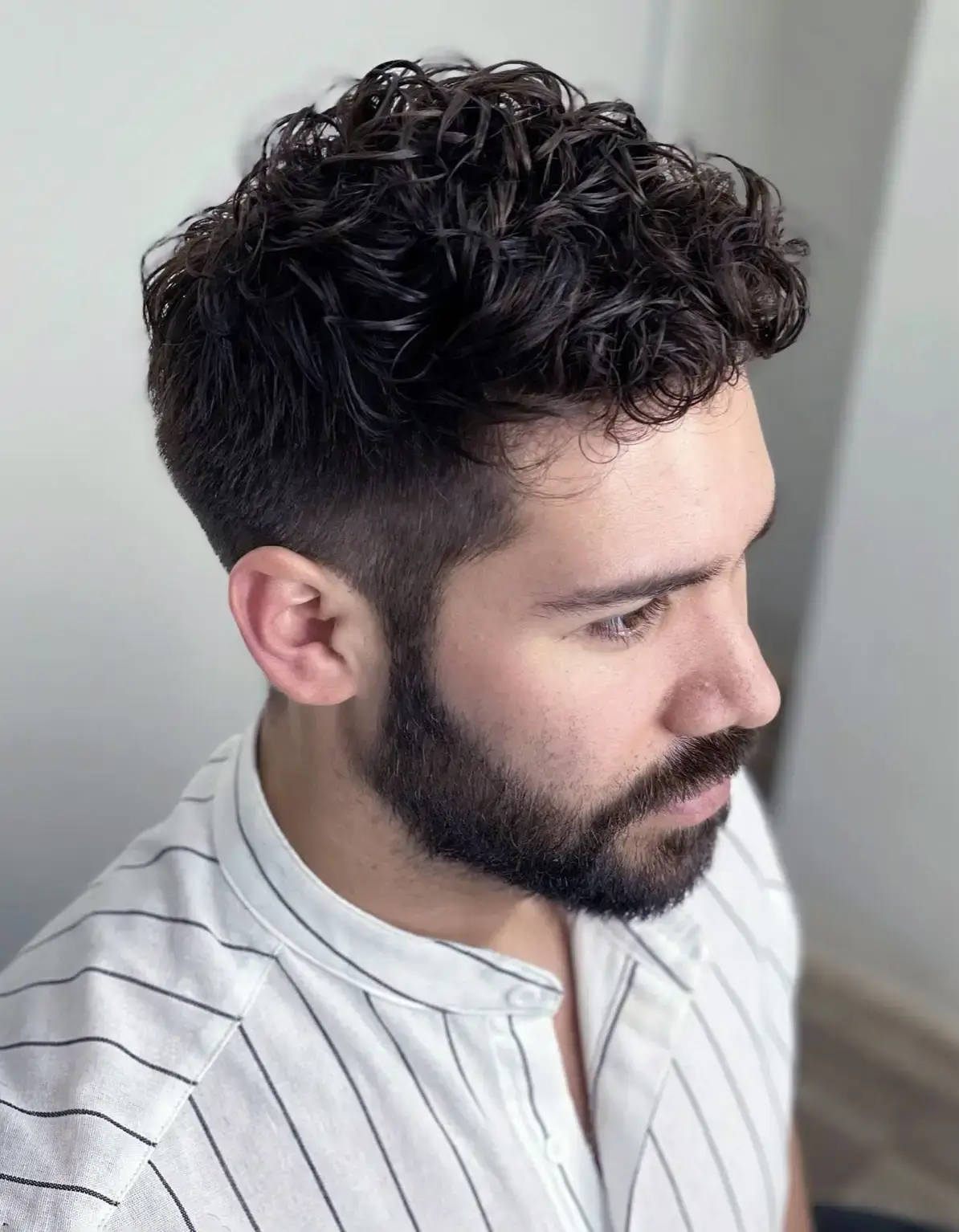 A stylish men's partial perm with short sides and a textured top
